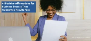 Smiling businesswoman reading a closed deal, celebrating success while working on her laptop.