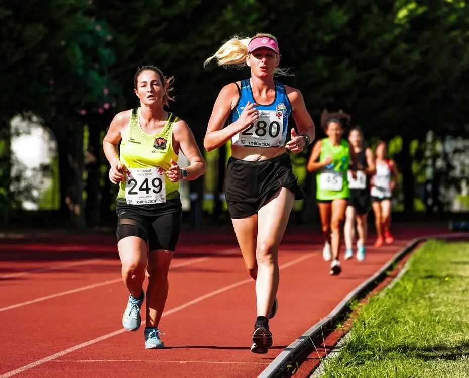 Sportswomen running on track during athletic contest. Overcoming Self-Doubt.