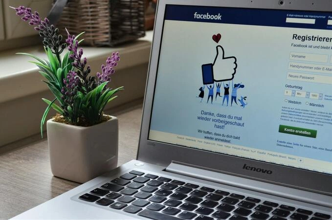 A laptop displaying the Facebook Login and sign-up screen, illustrating how to create or access an account on desktop.